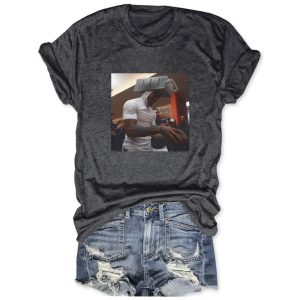 Dark gray cotton t-shirt by Icestork featuring a viral graphic of Caleb Williams wearing a cheese grater on his head while holding a football.